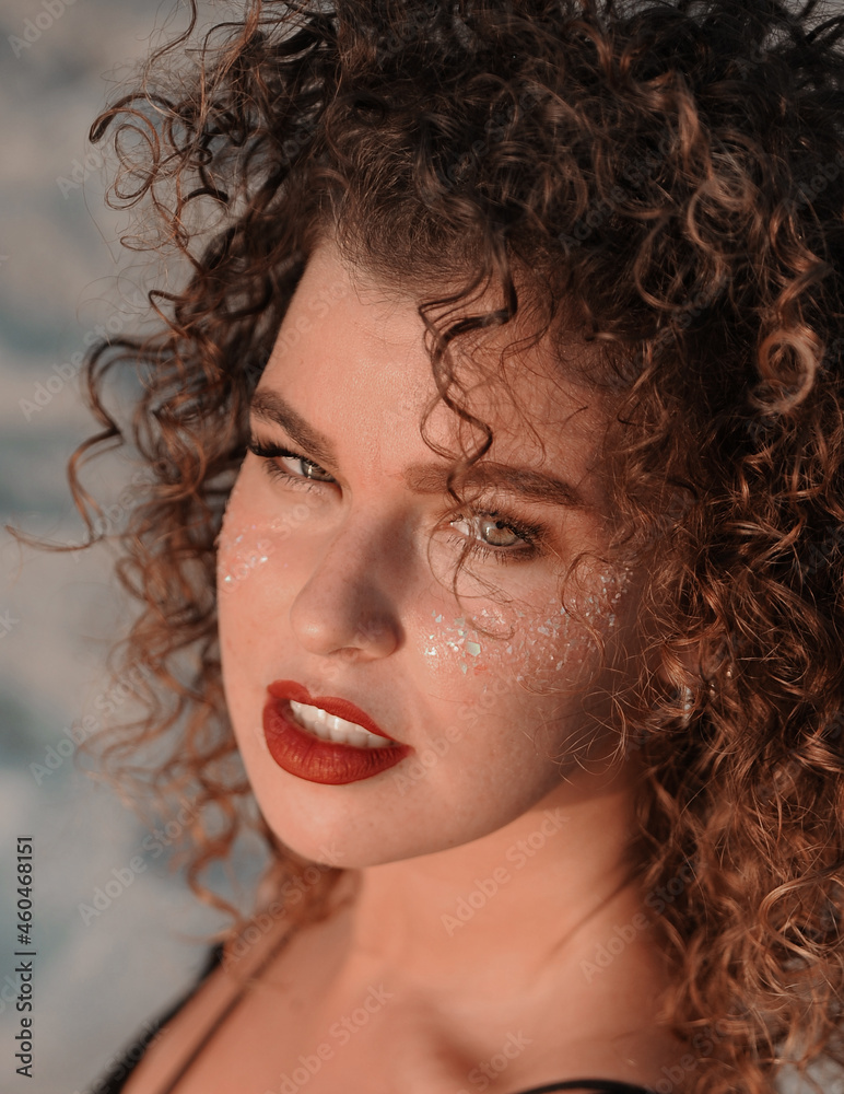 portrait of a beautiful young woman with a glitters on her face portrait of a beautiful young woman with a glitters on her face