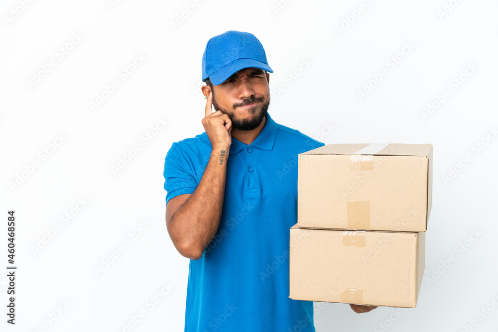 Delivery Ecuadorian man isolated on white background frustrated and covering ears Delivery Ecuadorian man isolated on white background frustrated and covering ears