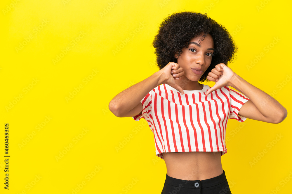 Young African American woman isolated on yellow background proud and self-satisfied