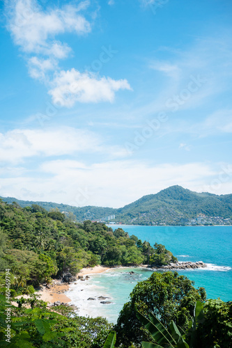 Landscape view beach sea and sand on summer. sea middle two mountains blue sky background.