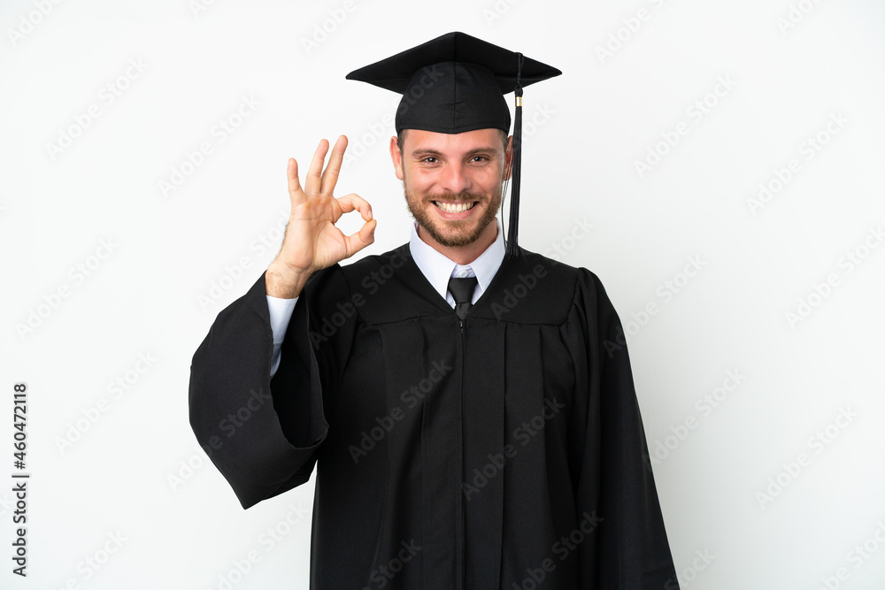 Young university Brazilian graduate isolated on white background showing ok sign with fingers Young university Brazilian graduate isolated on white background showing ok sign with fingers