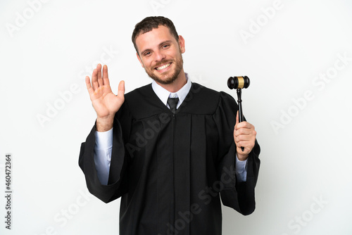 Judge caucasian man isolated on white background saluting with hand with happy expression