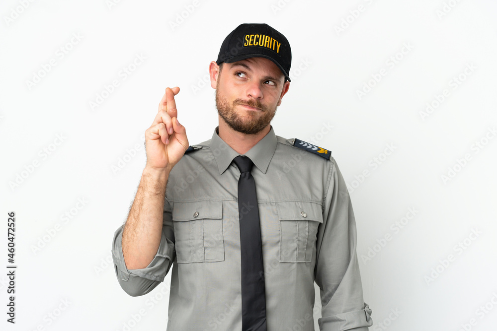Young security Brazilian man isolated on white background with fingers crossing and wishing the best Young security Brazilian man isolated on white background with fingers crossing and wishing the best