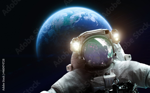 Fototapeta Naklejka Na Ścianę i Meble -  Astronaut in outer black space on orbit of Earth planet. Dark space and cosmonaut. Elements of this image furnished by NASA
