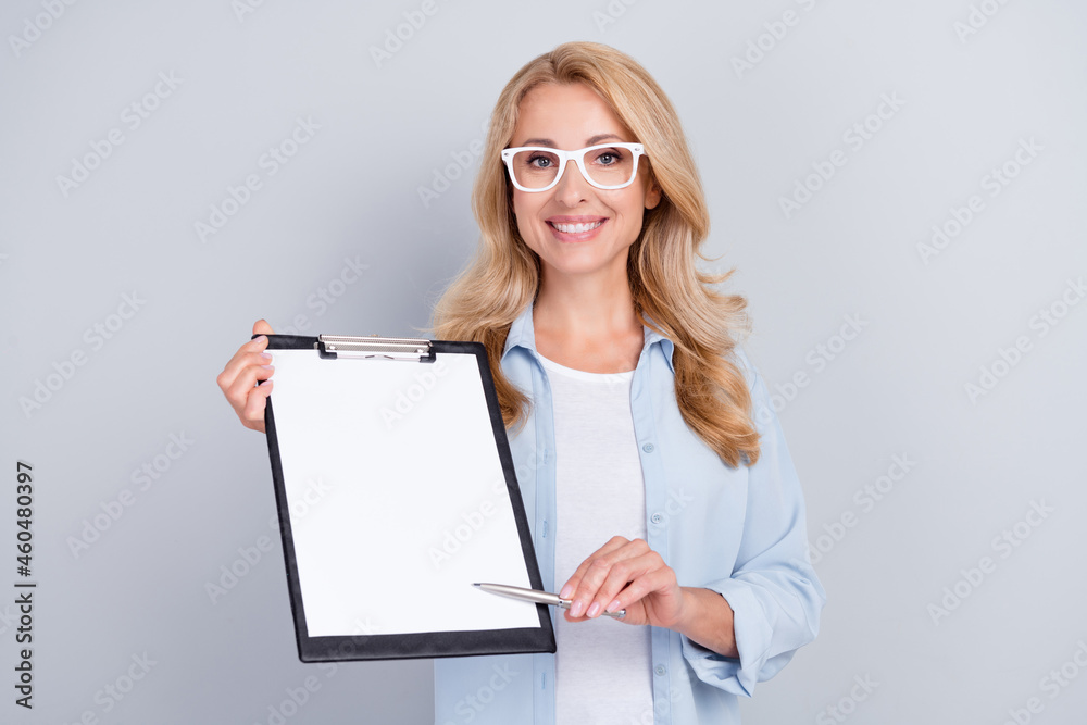 Photo of insurance agent show clipboard sign contract wear specs blue shirt isolated grey color background Photo of insurance agent show clipboard sign contract wear specs blue shirt isolated grey color background