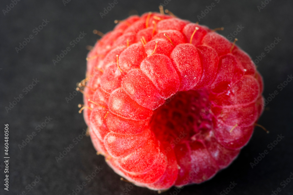 Macro Fruit: Ripe raspberry extreme close-up, black background, horizontal format Macro Fruit: Ripe raspberry extreme close-up, black background, horizontal format