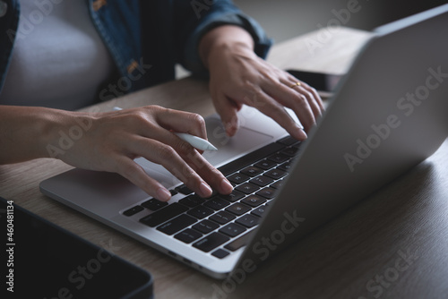 Young business woman online working, females hands typing on laptop computer and using digital tablet on office table at home, Student studing online, close up, E-learning concept
