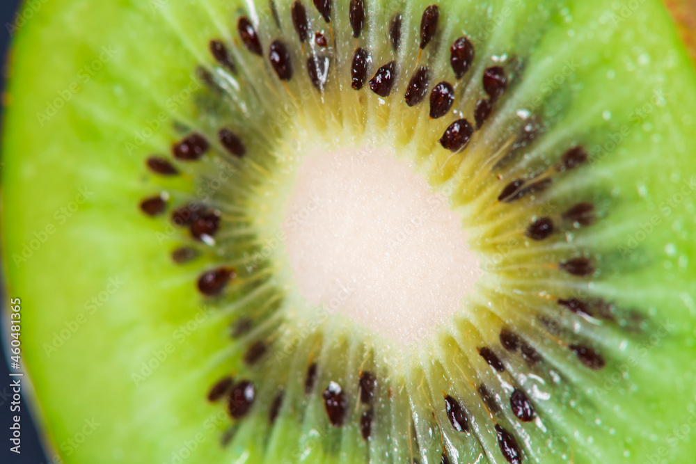 Macro Fruit: extreme close-up of a ripe kiwi fruit, black background, horizontal format Macro Fruit: extreme close-up of a ripe kiwi fruit, black background, horizontal format