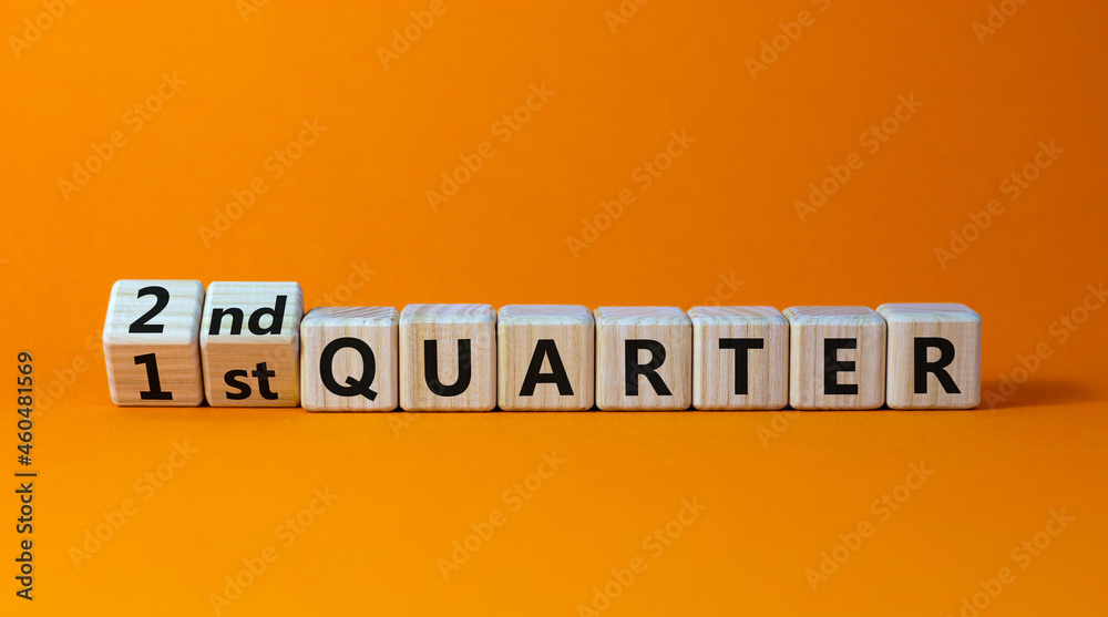 From 1st to 2nd quater symbol. Turned wooden cubes and changed words '1st quater' to '2nd quater'. Beautiful orange table, orange background. Business, happy 2nd quater concept, copy space. From 1st to 2nd quater symbol. Turned wooden cubes and changed words '1st quater' to '2nd quater'. Beautiful orange table, orange background. Business, happy 2nd quater concept, copy space.