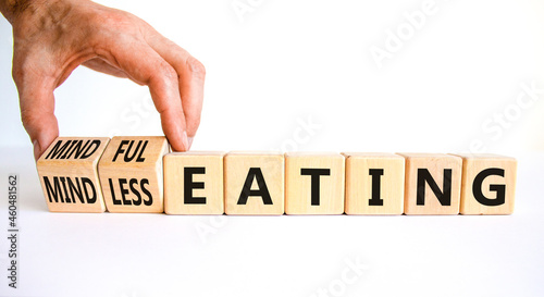 Mindful or mindless eating symbol. Doctor turns cubes and changes words mindless eating to mindful eating. Beautiful white background, copy space. Medical and mindful or mindless eating concept. photo