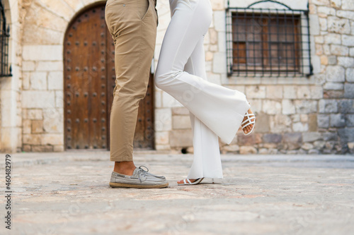 Slika na platnu Crop couple standing together in old city