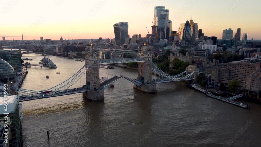 Aerial sunset view to the lifted Tower Bridge and skyline of the financial district City of London, Unuted Kingdom Aerial sunset view to the lifted Tower Bridge and skyline of the financial district City of London, Unuted Kingdom
