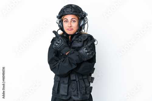SWAT caucasian woman isolated on white background pointing to the laterals having doubts