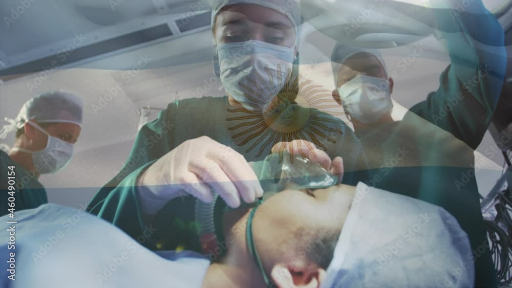 Animation of flag of argentina waving over surgeons in operating theatre Animation of flag of argentina waving over surgeons in operating theatre