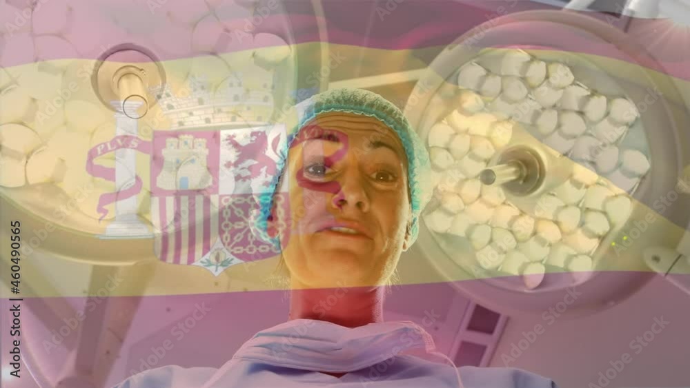 Animation of flag of spain waving over female surgeon in operating theatre Animation of flag of spain waving over female surgeon in operating theatre