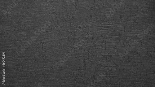 Background and texture of black decorative rough plaster close-up 