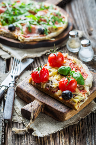 Pizza with tomatoes and basil. Pizza with mozzarella.