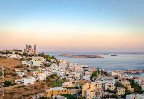 Scenic sunset in Ermoupolis, the capital of Cyclades, Greece, with the Church of the Resurrection of Our Savior on the left and the Aegean Sea in the background. Photo taken from Ano Syros. photo
