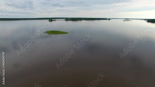 Takeoff over Lake.	Filming from a drone taking off over the lake. The lake is located among forests and swamps. On the island's lake.