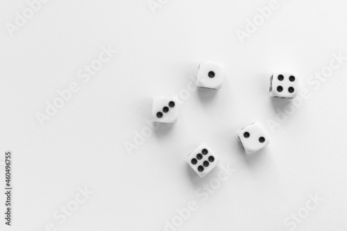 Gaming dice on white background. Playing cube with numbers. Items for board games. Flat lay  top view with copy space.