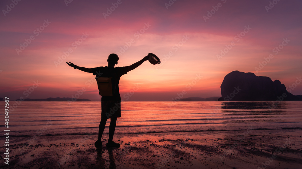 Silhouette happy man traveler arm up joy fun on summer vacation at sunset Pak Meng beach, Leisure outdoor lifestyle tourist travel Trang Thailand, Tourism beautiful destination place Asia holiday trip