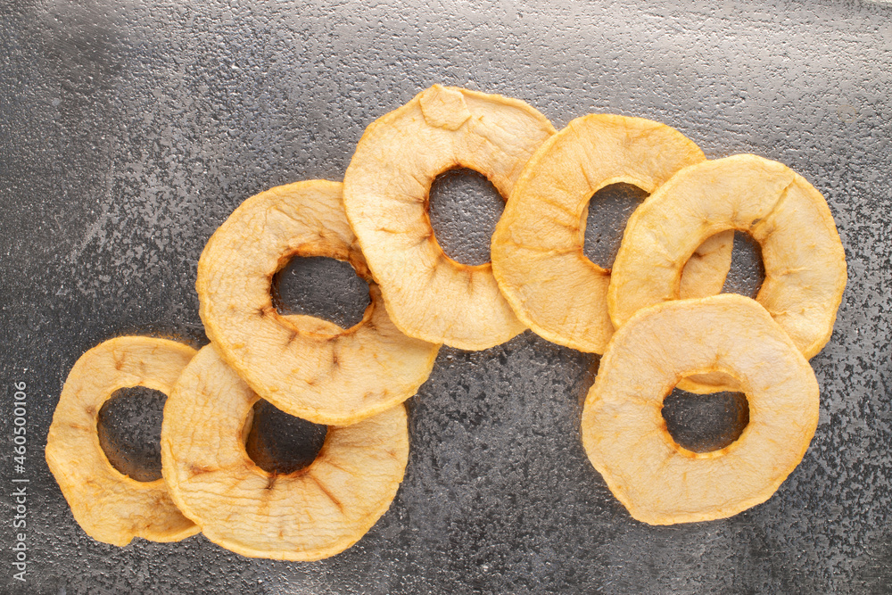 Several sweet crunchy, apple chips on a metal tray, close-up, top view. Several sweet crunchy, apple chips on a metal tray, close-up, top view.