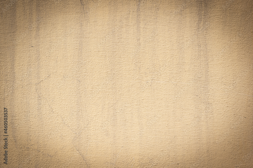 Fototapeta premium Yellow brown weathered cement concrete wall with water streaks and old texture, for backgrounds, design, templates