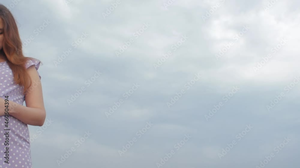 dreaming pregnant woman in field on background of beautiful clouds dreaming pregnant woman in field on background of beautiful clouds
