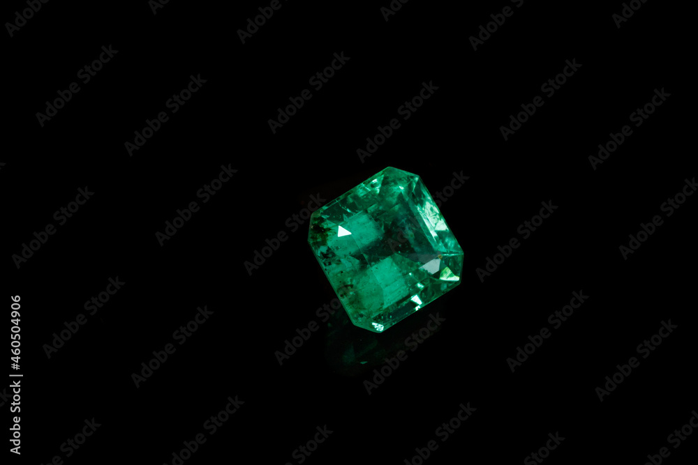 Macro mineral Emerald gemstone faceted on black background Macro mineral Emerald gemstone faceted on black background