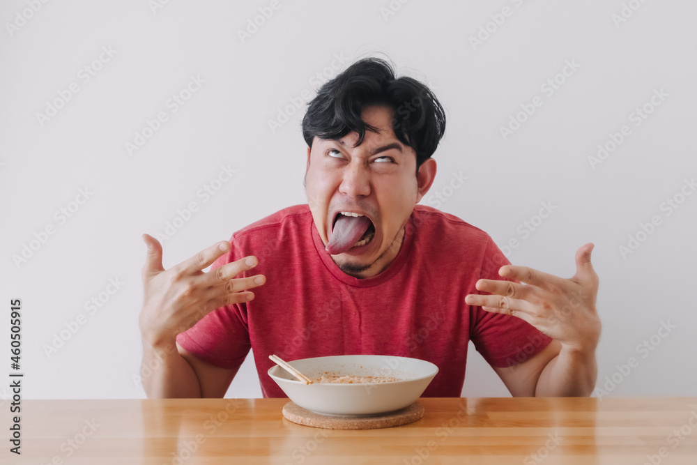 Funny face of Asian man eat very hot and spicy instant noodle. Stock ...
