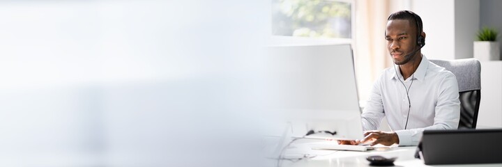 Business Service Agent With Headset At Computer