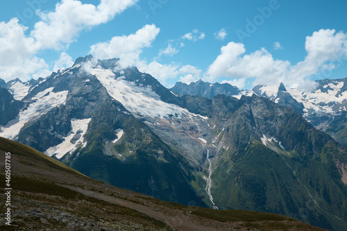 Landscape, mountain panorama, alpine meadows and mountain peaks in ice