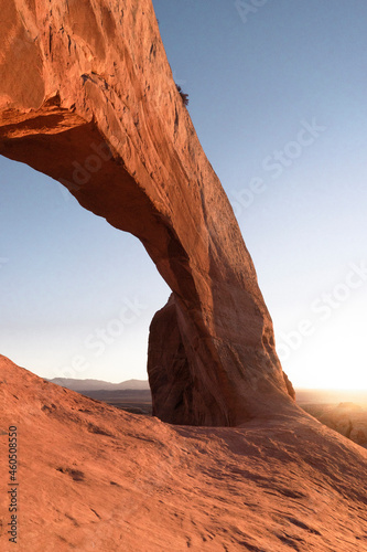 man hikig in arches national park at sunrise in moab utah