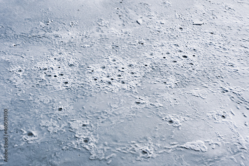 Frozen ice surface of a lake in winter, background texture