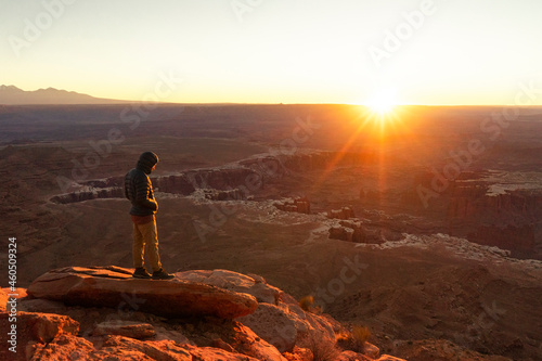 hiker at sunrise at canyonlands national park