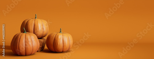 Seasonal background Banner with copy-space. Trio of Pumpkins on Orange color. Fall Concept. photo