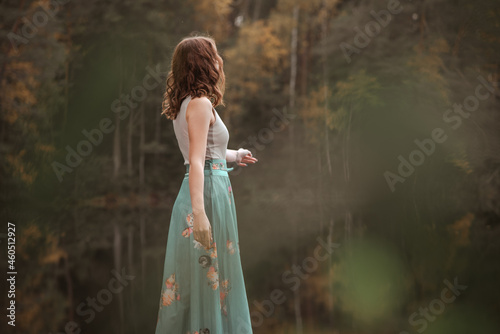 Wallpaper Mural Autumn portrait of a girl standing in a forest lake. The girl in the lake on the background of the forest. Torontodigital.ca