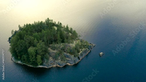 Aerial view of of small islands on a blue lake Saimaa. Landscape with drone. Blue lakes, islands and green forests from above on a cloudy summer morning. Lake landscape in Finland.	