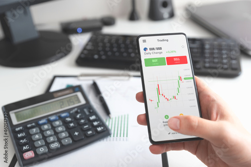 Investor using stock market trading mobile app photo