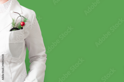 Christmas medicine banner with faceless doctor on green background