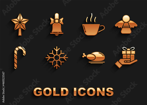 Set Snowflake, Christmas angel, Gift box in hand, Roasted turkey or chicken, candy cane with stripes, Coffee cup, star and Merry ringing bell icon. Vector © Oksana