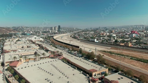 Aerial: Border town of San Ysidro with a view across the Tijuana River border to Tijuana. California, USA photo