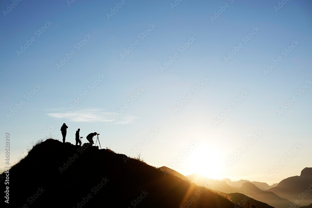 Group of photographers taking pictures at sunset in the Dolomites, Passo Giau, Italy, Europe