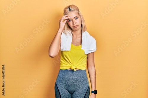 Beautiful blonde sports woman wearing workout outfit worried and stressed about a problem with hand on forehead, nervous and anxious for crisis © Krakenimages.com