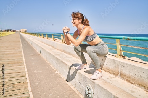 Young caucasian woman wearing sportswear training at seaside