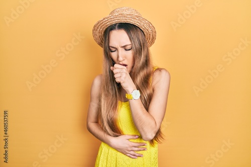 Young blonde girl wearing summer hat feeling unwell and coughing as symptom for cold or bronchitis. health care concept.