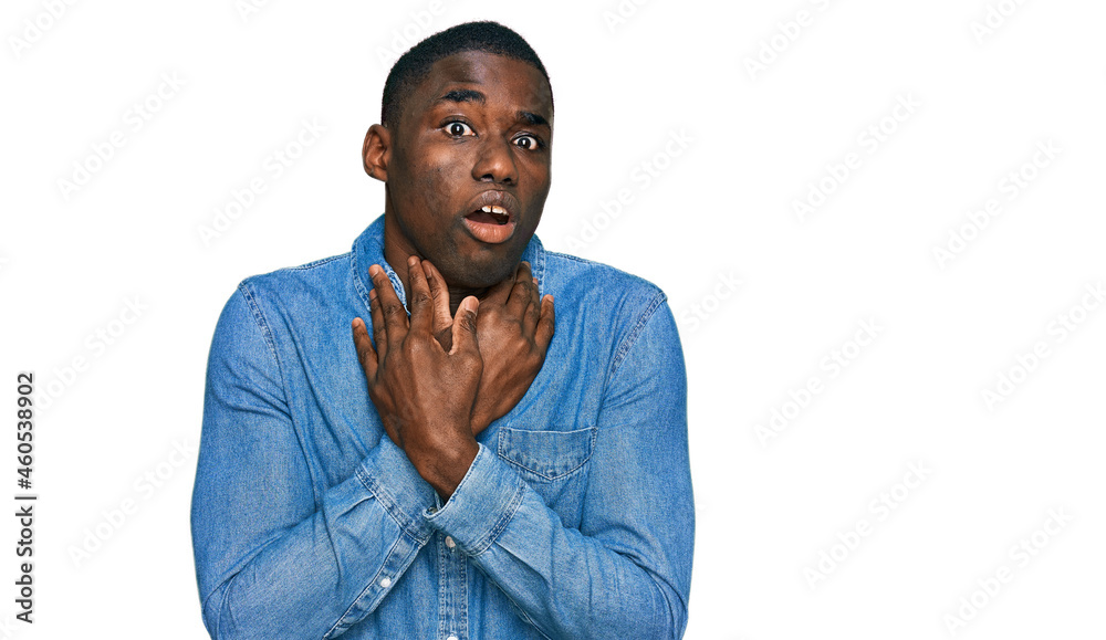 Young african american man wearing casual clothes shouting and suffocate because painful strangle. health problem. asphyxiate and suicide concept. Young african american man wearing casual clothes shouting and suffocate because painful strangle. health problem. asphyxiate and suicide concept.
