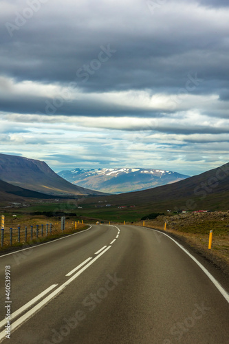 summer road trip on an open high way in Route 1 in Iceland with dramatic mountain landscape on the background. © Nathaniel Gonzales
