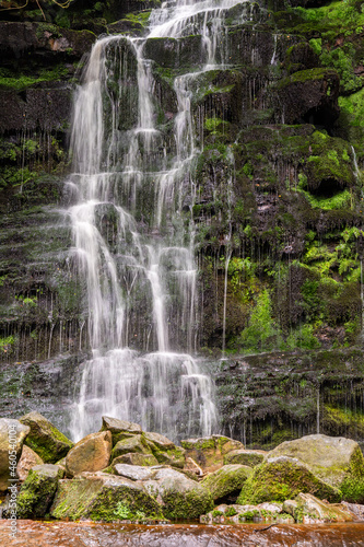 A waterfall cascading down over rocks in the Peak District
