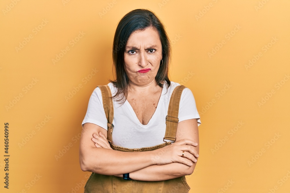 Obraz premium Middle age hispanic woman wearing casual clothes skeptic and nervous, disapproving expression on face with crossed arms. negative person.